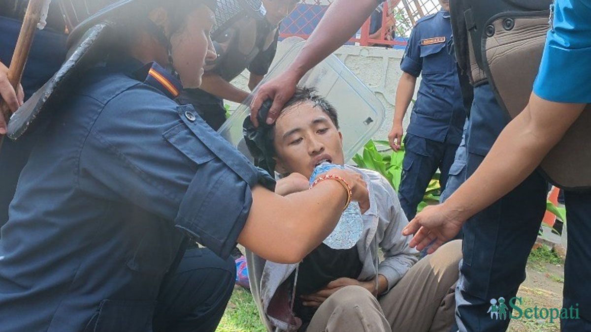 १८ वर्षीय विवश घर्ती मगरलाई गोली लागेपछि उद्धार गर्दै प्रहरी। तस्बिर सौजन्य: राकेश गुरूङ